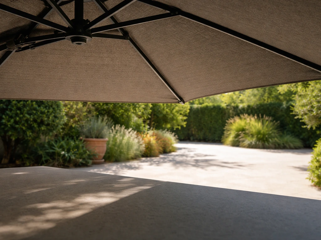 Underside of a closed cantilever umbrella showing a shaded area contrasted with bright direct sun outside.