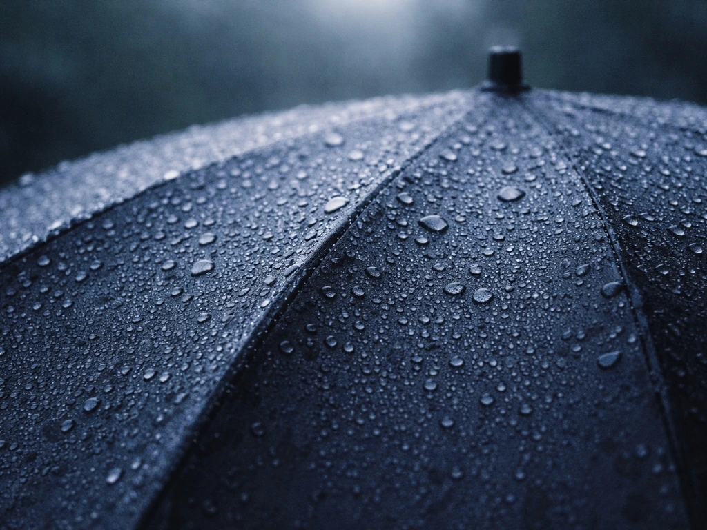Close-up of dew beading on an open umbrella canopy, highlighting standing moisture.